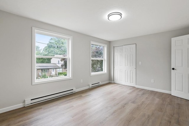 18 Nanita St, Worcester, MA 01604 - unfurnished bedroom featuring a baseboard heating unit, wood finished floors, and a closet