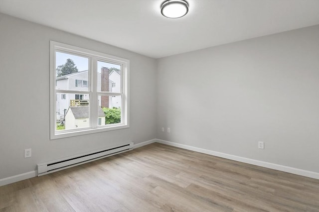 18 Nanita St, Worcester, MA 01604 - empty room with a baseboard radiator and wood finished floors
