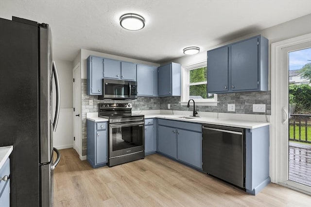 18 Nanita St, Worcester, MA 01604 - kitchen featuring stainless steel appliances, light wood-type flooring, blue cabinets, and light countertops