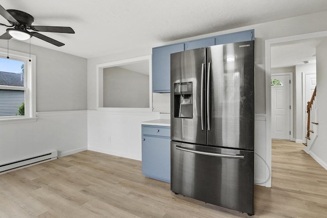 18 Nanita St, Worcester, MA 01604 - kitchen featuring stainless steel refrigerator with ice dispenser, blue cabinetry, a ceiling fan, light wood-style flooring, and baseboard heating