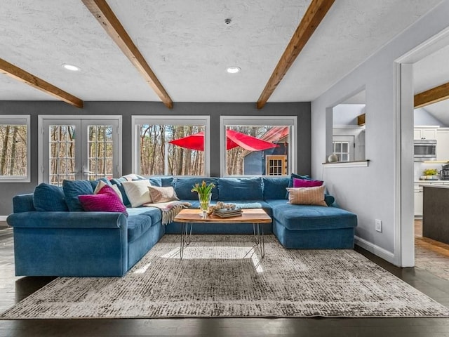 living room featuring wood finished floors, beamed ceiling, french doors, and baseboards