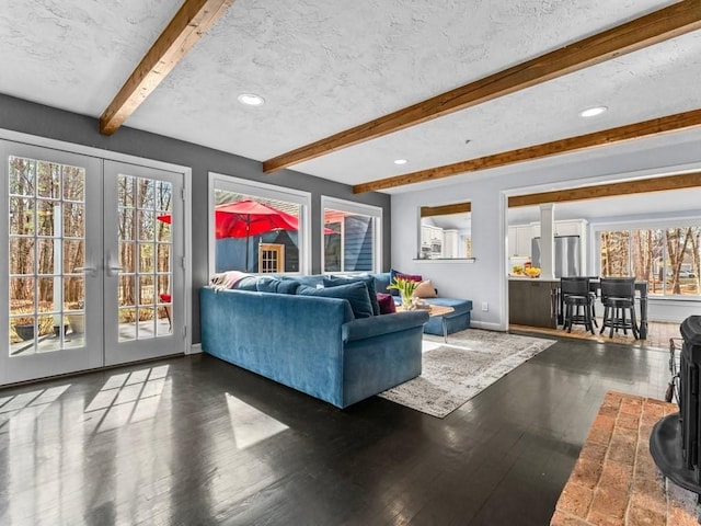 living room featuring french doors, baseboards, and a textured ceiling