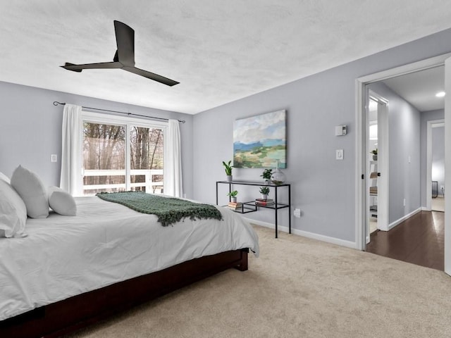 carpeted bedroom featuring ceiling fan and baseboards