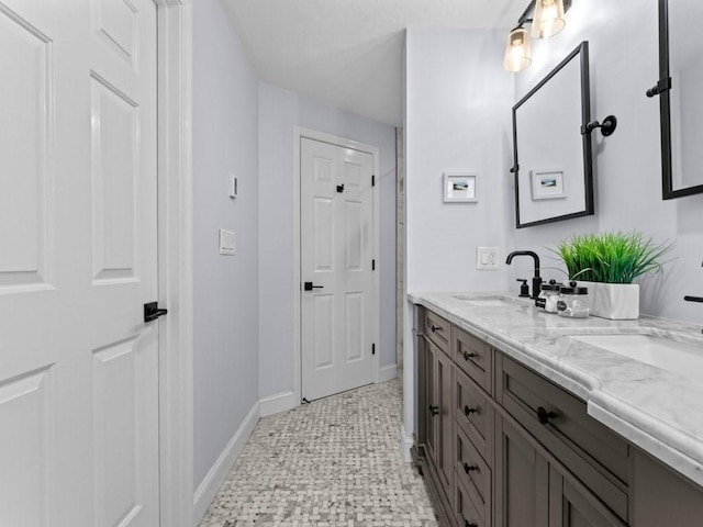 bathroom with vanity and baseboards