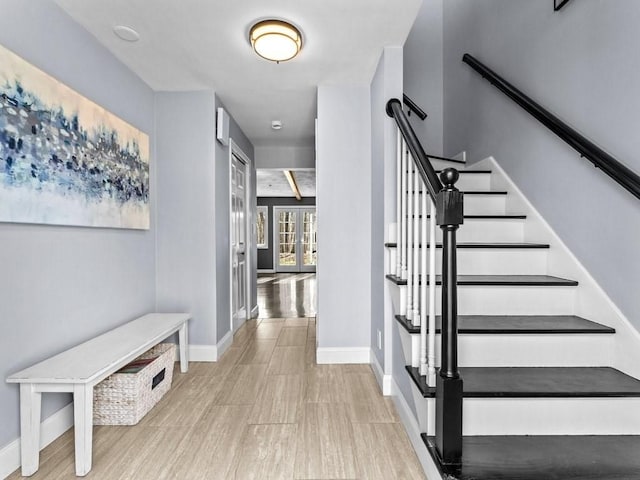 entrance foyer with french doors, baseboards, and stairs