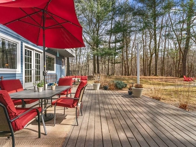 wooden terrace featuring french doors and outdoor lounge area