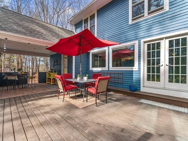 deck featuring outdoor dining space and french doors