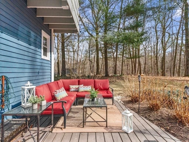 wooden terrace with an outdoor living space