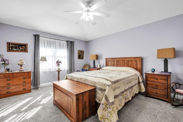 bedroom featuring carpet floors, lofted ceiling, baseboards, and a ceiling fan