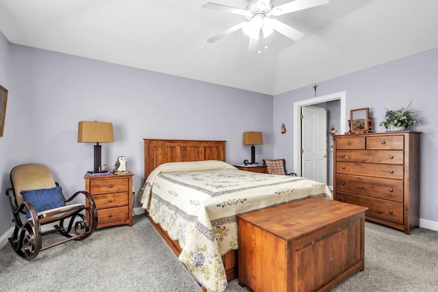 bedroom featuring a ceiling fan, light colored carpet, vaulted ceiling, and baseboards