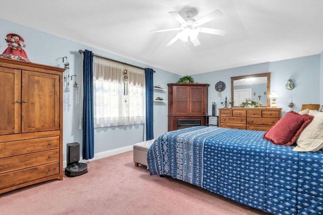 carpeted bedroom with ceiling fan and baseboards