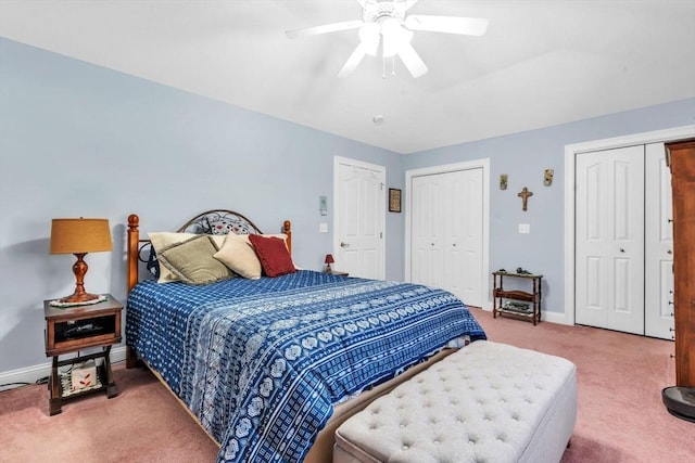 carpeted bedroom featuring baseboards, a ceiling fan, and multiple closets