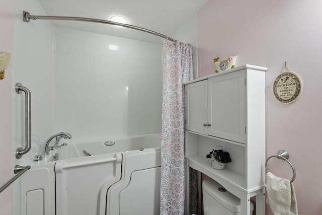 full bathroom with toilet and a tub