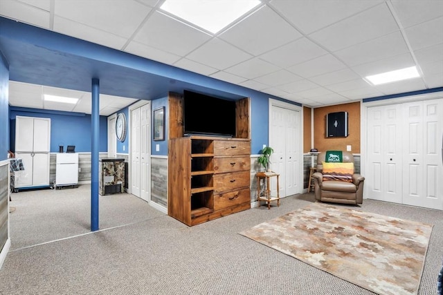 interior space with carpet floors and a paneled ceiling