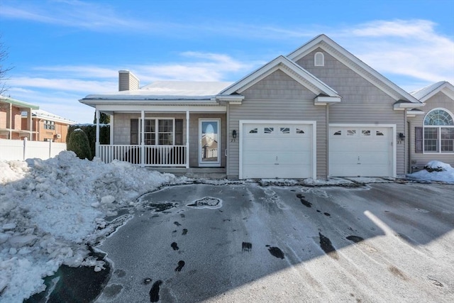 ranch-style home with a garage, fence, and a porch