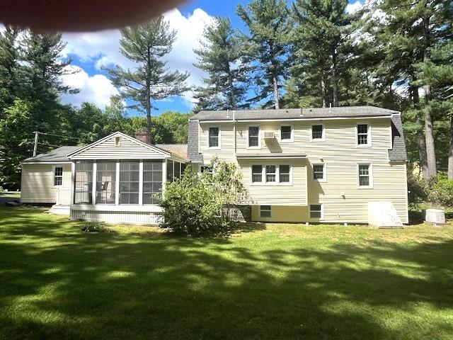 26 N Hill Rd, Westford, MA 01886 - back of house featuring a sunroom, a lawn, and a chimney