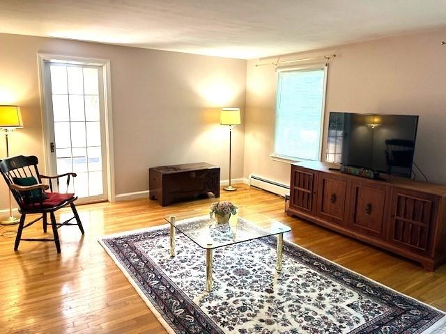 26 N Hill Rd, Westford, MA 01886 - living room with a baseboard heating unit, wood finished floors, and baseboards