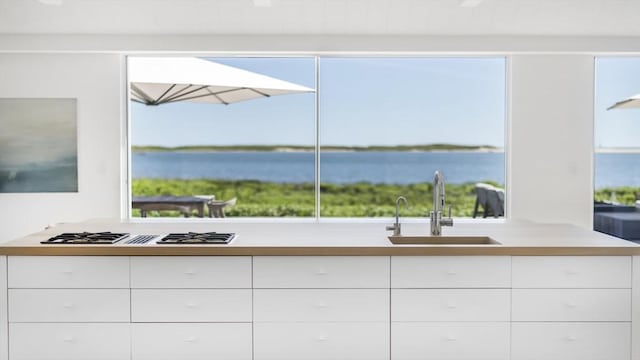 61 Butlers Cove Rd, Edgartown, MA 02539 - kitchen with gas stovetop, modern cabinets, white cabinets, and a water view