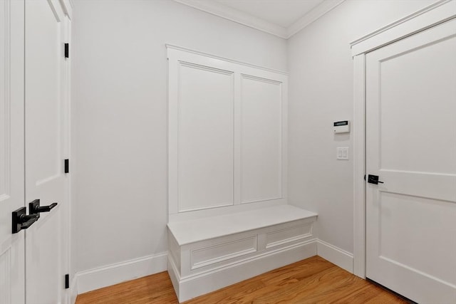 mudroom with ornamental molding and light hardwood / wood-style flooring