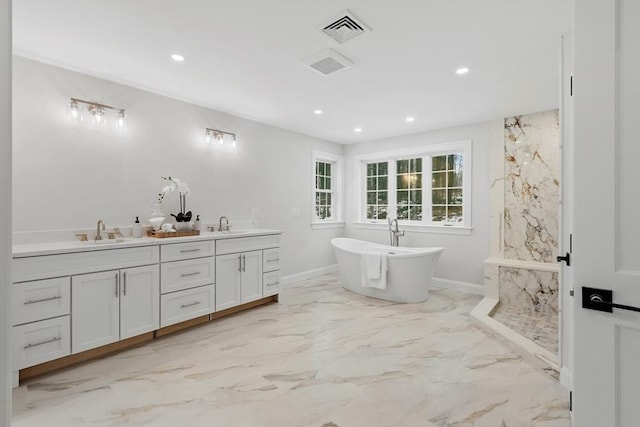 bathroom with vanity and a bath