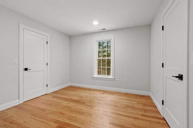 unfurnished room with light hardwood / wood-style floors