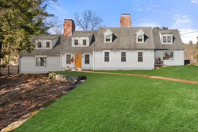 rear view of house with a yard, fence, roof with shingles, and a chimney