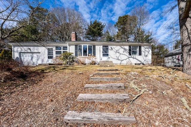 single story home featuring an attached garage and a chimney