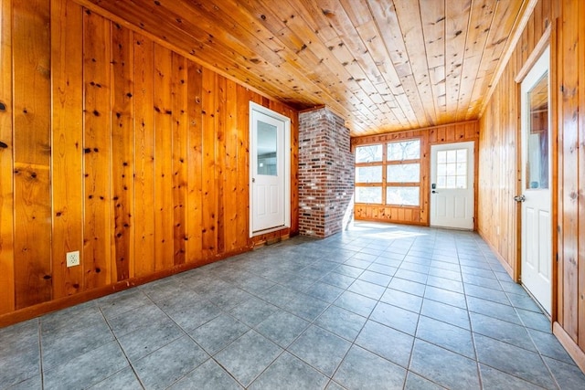 unfurnished room with wood walls, wooden ceiling, and light tile patterned flooring