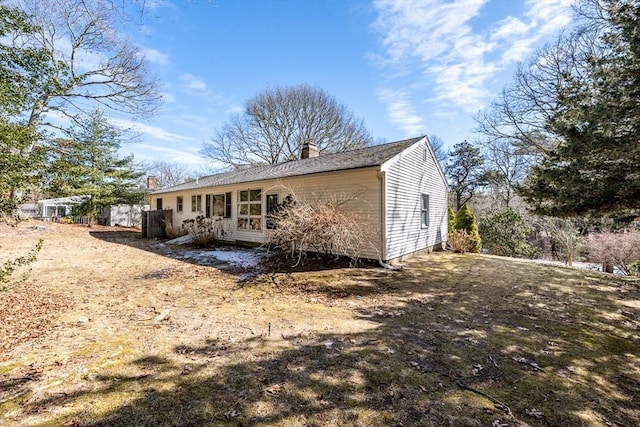 back of property with a chimney