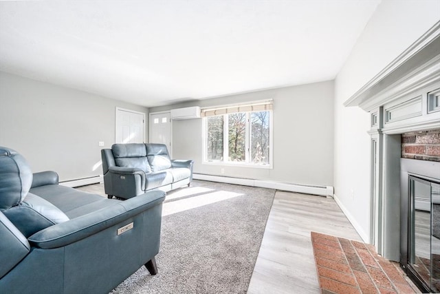 living room featuring baseboard heating, a wall unit AC, light wood-style flooring, and baseboards