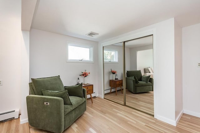 168 Varao Ave, Somerset, MA 02726 - sitting room with a baseboard radiator, light wood-style flooring, and a baseboard heating unit