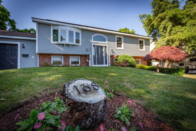 168 Varao Ave, Somerset, MA 02726 - bi-level home with brick siding, a front yard, and an attached garage