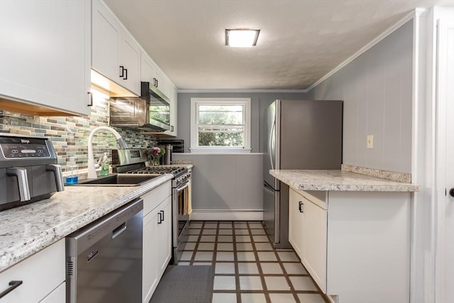 168 Varao Ave, Somerset, MA 02726 - kitchen with appliances with stainless steel finishes, tile patterned floors, white cabinetry, decorative backsplash, and crown molding