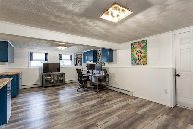 168 Varao Ave, Somerset, MA 02726 - office with a baseboard heating unit, wood finished floors, baseboard heating, and a decorative wall