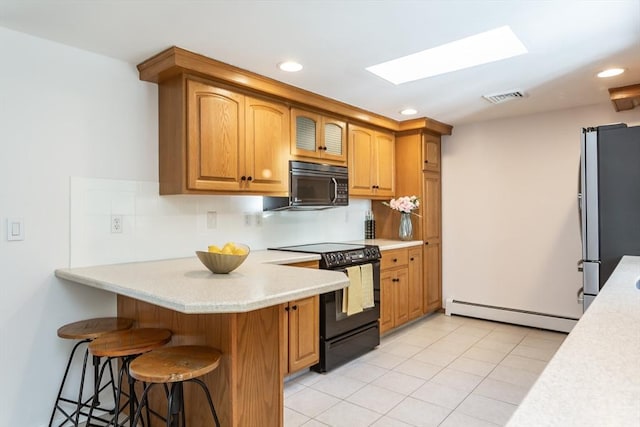 168 Varao Ave, Somerset, MA 02726 - kitchen featuring black appliances, baseboard heating, light countertops, a kitchen bar, and a peninsula