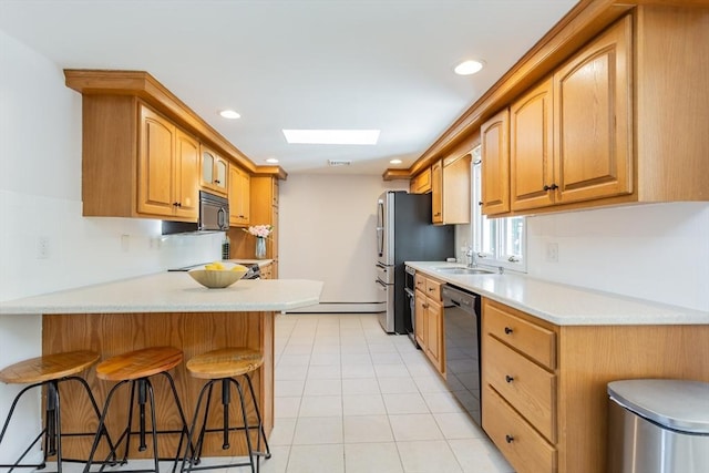 168 Varao Ave, Somerset, MA 02726 - kitchen with black appliances, a breakfast bar area, a peninsula, light countertops, and recessed lighting