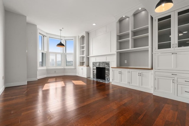 416 Marlborough Unit 608, Boston, MA 02116 - unfurnished living room with dark wood-style floors, built in shelves, a fireplace, and recessed lighting