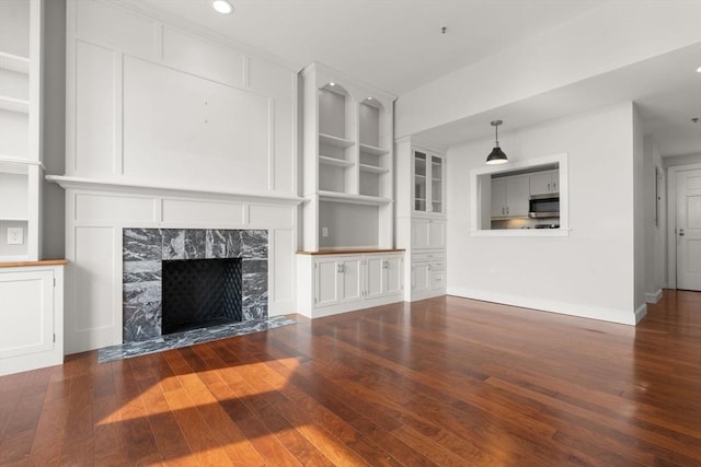 416 Marlborough Unit 608, Boston, MA 02116 - unfurnished living room with hardwood / wood-style flooring, a fireplace, recessed lighting, and built in shelves