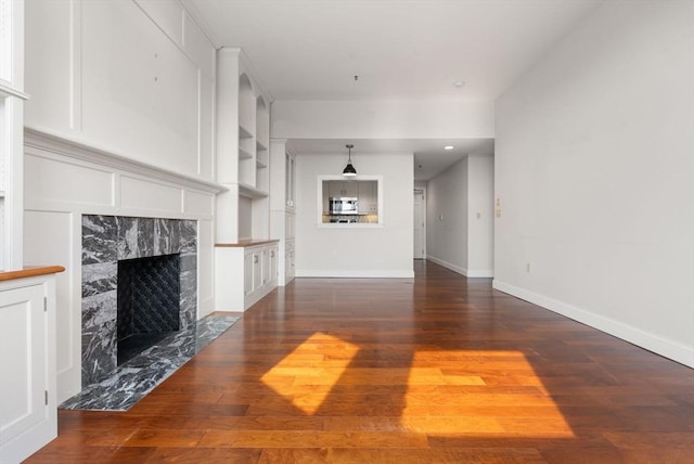 416 Marlborough Unit 608, Boston, MA 02116 - unfurnished living room featuring hardwood / wood-style floors, a premium fireplace, and built in shelves