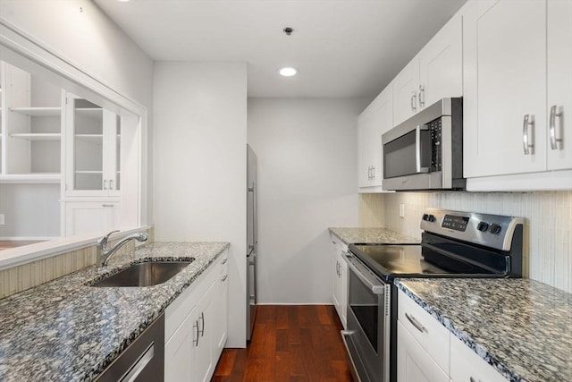 416 Marlborough Unit 608, Boston, MA 02116 - kitchen with appliances with stainless steel finishes, dark stone counters, dark wood-style flooring, backsplash, and white cabinets