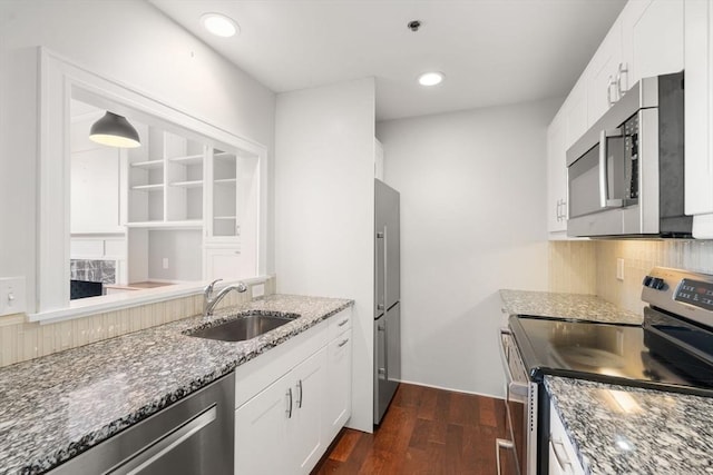 416 Marlborough Unit 608, Boston, MA 02116 - kitchen featuring stainless steel appliances, dark stone countertops, dark wood finished floors, backsplash, and white cabinets