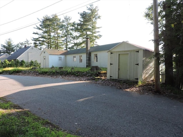 view of front of home featuring a storage shed