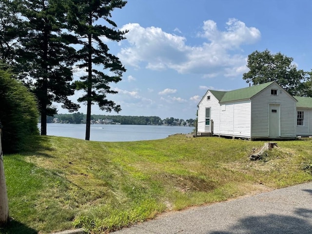 view of yard with a water view and an outbuilding