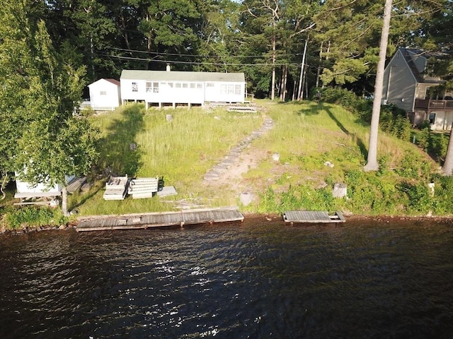 birds eye view of property with a water view