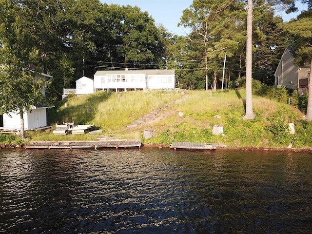 exterior space featuring a dock and a water view