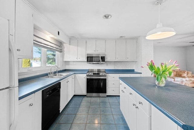 kitchen featuring appliances with stainless steel finishes, white cabinets, a sink, and tile patterned floors