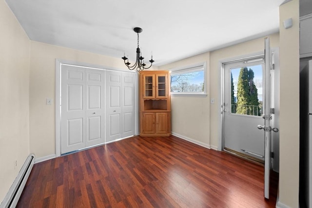 unfurnished dining area featuring a baseboard radiator, baseboards, and dark wood-style flooring