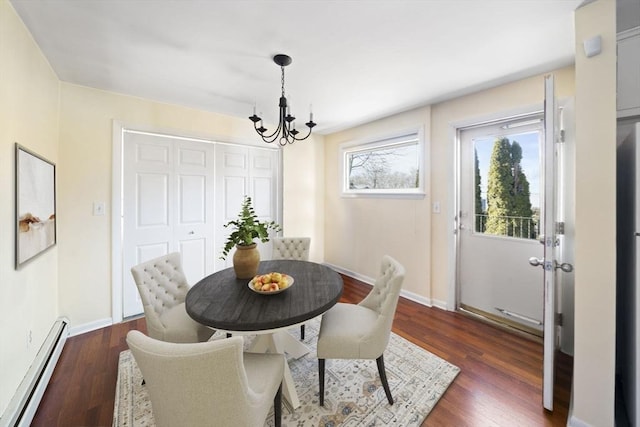 dining area featuring a baseboard heating unit, a notable chandelier, dark wood finished floors, and baseboards