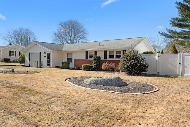 ranch-style home featuring a garage, a gate, fence, a front lawn, and brick siding