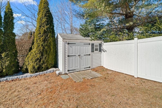 view of shed with fence